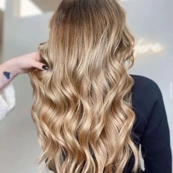 Close-up of golden balayage waves, a Salon Joy guest's finished look