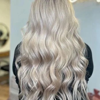 Close-up of platinum blonde waves, a Salon Joy guest's finished look