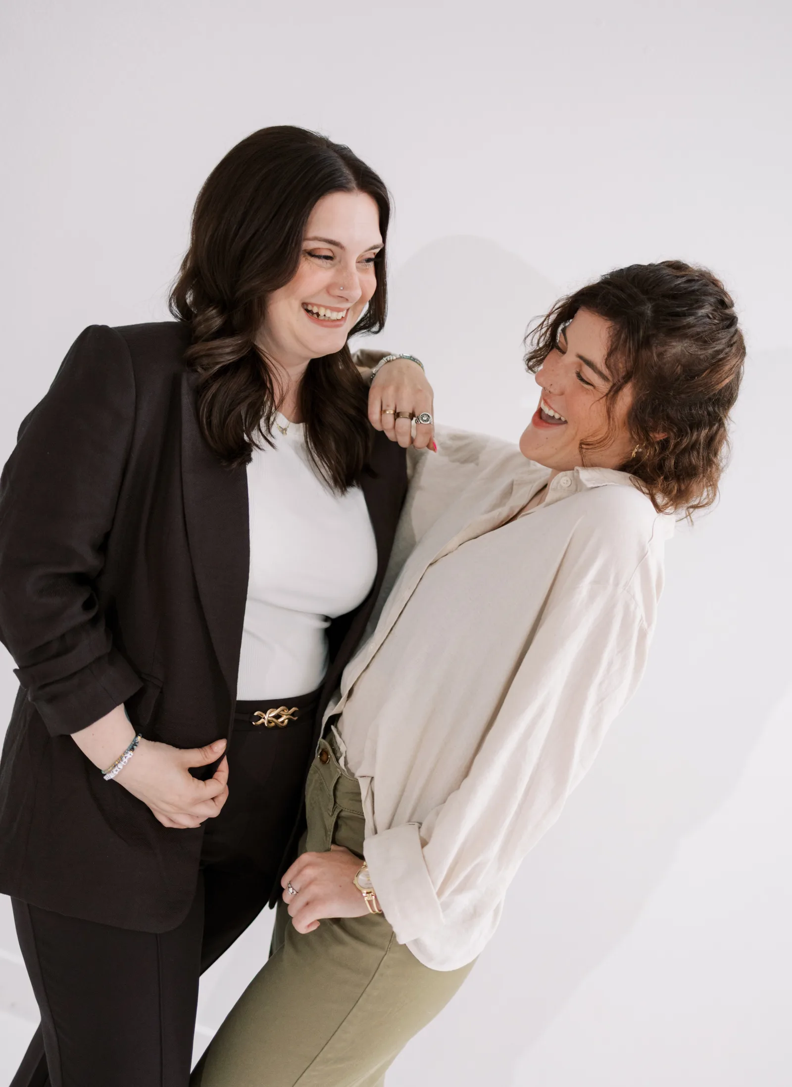 Two Salon Joy team members laughing together